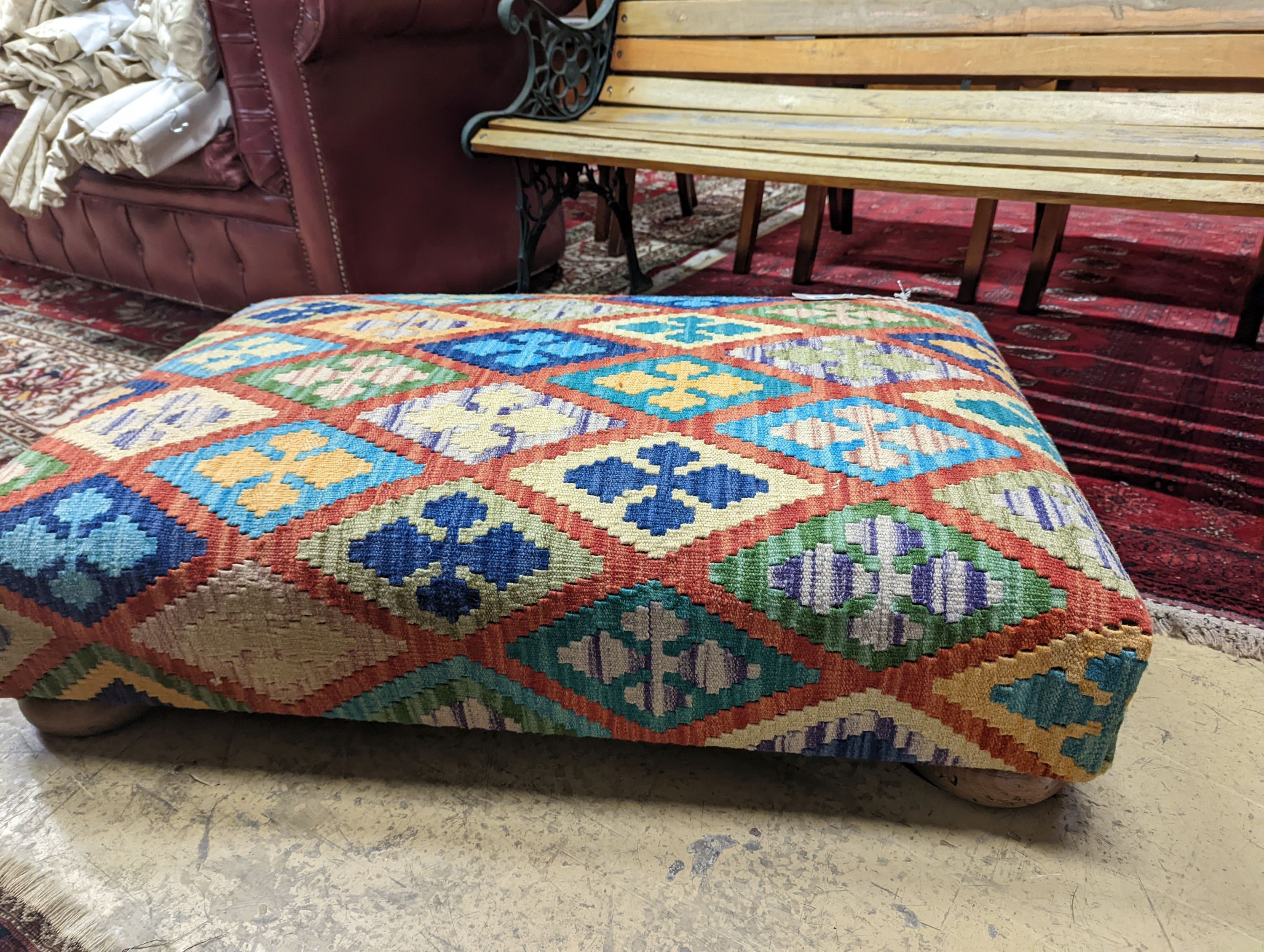 A rectangular Kilim footstool on flat bun feet, length 98cm, depth 62cm, height 22cm